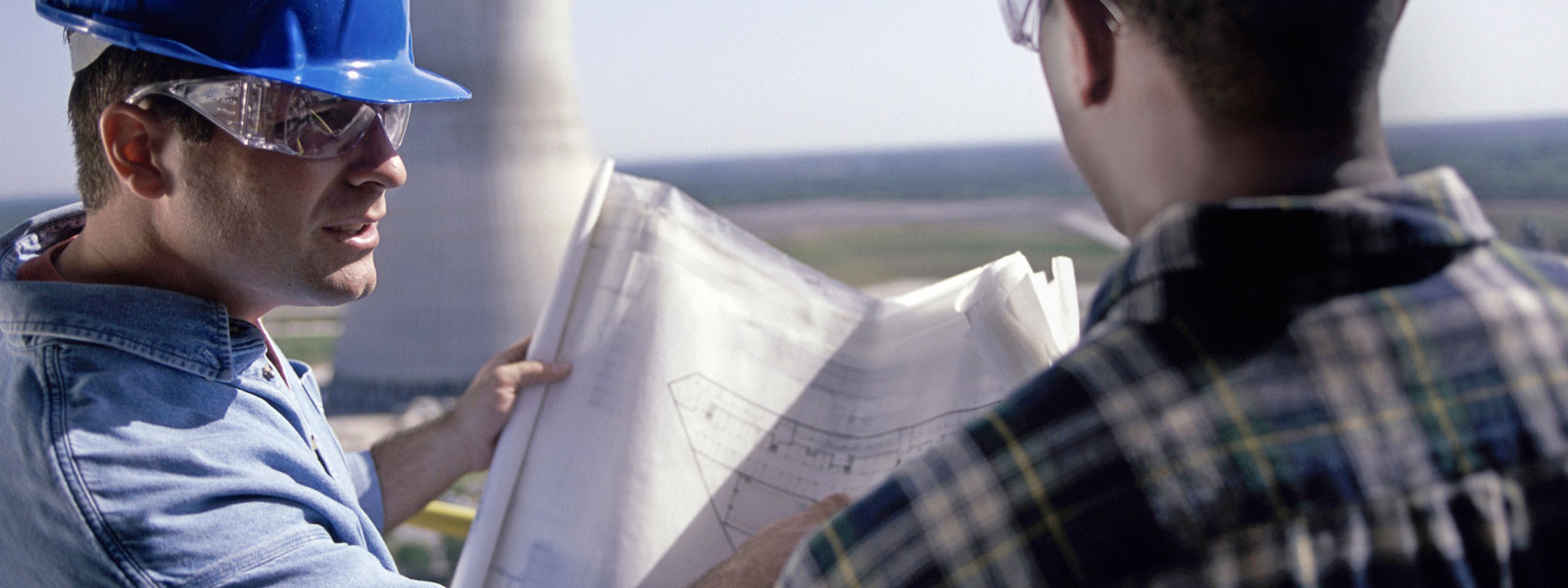 two workers discussing a build plan